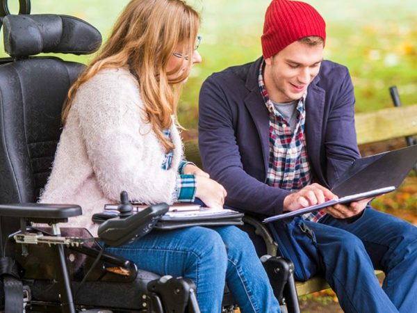 Student helping friend with disability